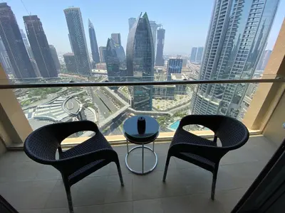 two chairs and a table in front of a window at SuperHost EMAAR Residences Fashion Avenue - Former Address Dubai Mall Studio's & 1 BR in Dubai