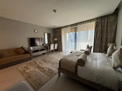 a large bedroom with a large bed and a couch at SuperHost EMAAR Residences Fashion Avenue - Former Address Dubai Mall Studio's & 1 BR in Dubai