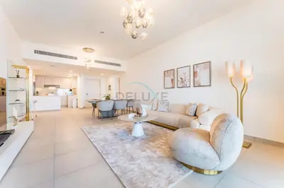 a living room with a couch and a table at Balcony Overlooking Community 2BR with Assistant Room, Minutes Away From the Beach, Madinat Jumeirah Living Rahaal 2, Jumeirah by Deluxe Holiday Homes in Dubai