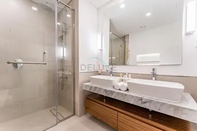 a bathroom with a sink and a shower at Balcony Overlooking Community 2BR with Assistant Room, Minutes Away From the Beach, Madinat Jumeirah Living Rahaal 2, Jumeirah by Deluxe Holiday Homes in Dubai