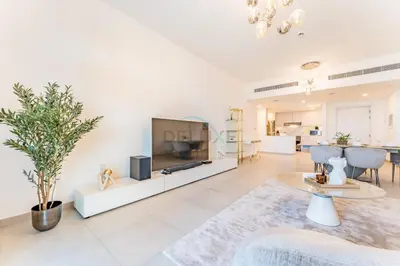 a living room with a flat screen tv and a living room at Balcony Overlooking Community 2BR with Assistant Room, Minutes Away From the Beach, Madinat Jumeirah Living Rahaal 2, Jumeirah by Deluxe Holiday Homes in Dubai