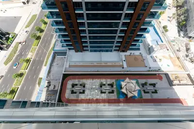 an overhead view of a tall building with an umbrella at Modern Studio in Elite Business Bay Residence in Dubai