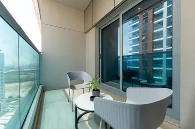 a balcony with a table and chairs and a window at Modern Studio in Elite Business Bay Residence in Dubai