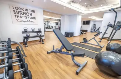 a gym with treadmills and ellipticals in a room at Modern Studio in Elite Business Bay Residence in Dubai
