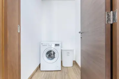 a washer and dryer sitting in a room at VacayLettings - 1 BHK - Near Jebel Ali Port- IKEA - Metro 20 Min - Al Furjan in Dubai