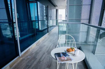 a plate of food on a white table on a balcony at Experience Modern Comforts Near Iconic Dubai Mall and Burj Khalifa in Dubai