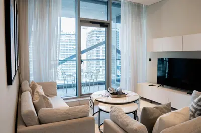 a living room with a couch and a table at Experience Modern Comforts Near Iconic Dubai Mall and Burj Khalifa in Dubai