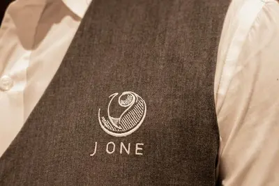 a close up of a person wearing a jone tie at Experience Modern Comforts Near Iconic Dubai Mall and Burj Khalifa in Dubai