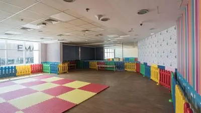 an empty classroom with colorful chairs and a blackboard at Stunning Studio in Burj Al Nujoom in Dubai