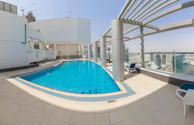 a swimming pool on the roof of a building at Stunning Studio in Burj Al Nujoom in Dubai