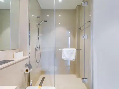 a bathroom with a shower with a glass door at TRPS - Act One Act Two Towers, Downtown Dubai, Iconic 3BR plus Maids - with Burj Khalifa Views - Near Dubai Mall in Dubai