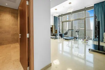 a gym with treadmills and exercise equipment in a building at Marina Gate 2 Penthouse Iconic Views in Dubai