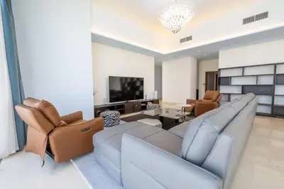 a living room with a couch and chairs and a television at Marina Gate 2 Penthouse Iconic Views in Dubai