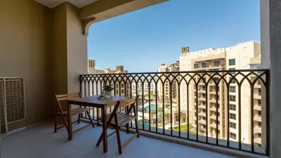 a balcony with a table and chairs on a balcony at 1br Luxury Complex Burj AlArab View 5min to beach in Dubai