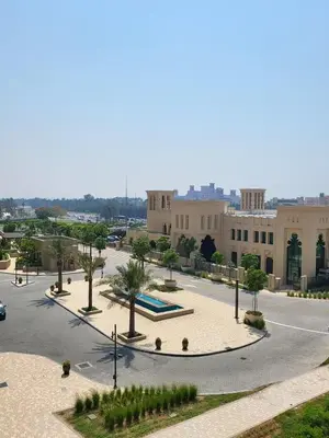 a view of a building with trees and a street at 1br Luxury Complex Burj AlArab View 5min to beach in Dubai