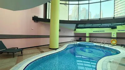 a large swimming pool in a building with a large window at Prime Location - Marina full View - Perfect for holidays in Dubai