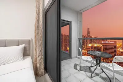 a bedroom with a bed and a table on a balcony at Prime Location - Marina full View - Perfect for holidays in Dubai