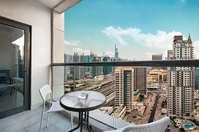 a balcony with a table and chairs and a view of a city at Prime Location - Marina full View - Perfect for holidays in Dubai