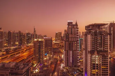 a city skyline at night with traffic at Prime Location - Marina full View - Perfect for holidays in Dubai
