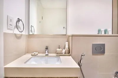 a bathroom with a sink and a mirror at Luxury 4 Bedroom High-Floor Apartment, Spectacular Burj Khalifa & Fountain Views, Steps Away from Dubai Mall - Downtown Dubai by Stayfinity in Dubai