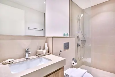 a bathroom with a sink and a shower at Luxury 4 Bedroom High-Floor Apartment, Spectacular Burj Khalifa & Fountain Views, Steps Away from Dubai Mall - Downtown Dubai by Stayfinity in Dubai