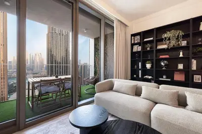 a living room with a couch and a table with a view at Spacious 4-Bedroom Apartment with Full Fountain and Burj Khalifa Views - 10 min Walk to Dubai Mall in Dubai