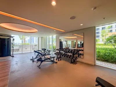 a gym with several treadmills and a large window at Elegant 1BR Apartment with Private Beach Access! in Dubai