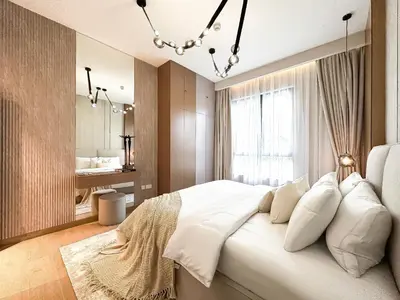 a bedroom with a large white bed and a bathroom at Chic 1BR on La Mer Upgraded & Elegant in Dubai