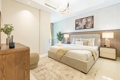 a bedroom with a king sized bed and a television at 2BR with Balcony Overlooking City and Burj Khalifa, Minutes Away from Dubai Mall, Paramount Tower Hotel and Residences, Business Bay by Deluxe Holiday Homes in Dubai