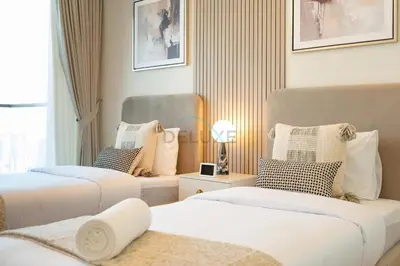 a hotel room with two beds and a window at 2BR with Balcony Overlooking City and Burj Khalifa, Minutes Away from Dubai Mall, Paramount Tower Hotel and Residences, Business Bay by Deluxe Holiday Homes in Dubai