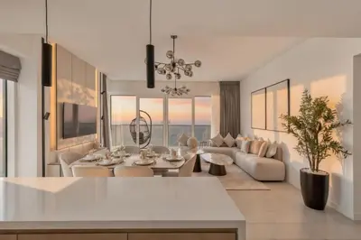 a living room with a couch and a table at La Vie Jumeirah Beach Residence 3 Bedroom Beachfront Apartment with Palm Views in Dubai