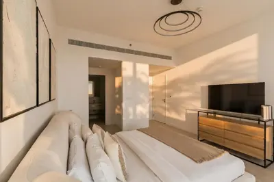 a living room with a couch and a television at La Vie Jumeirah Beach Residence 3 Bedroom Beachfront Apartment with Palm Views in Dubai