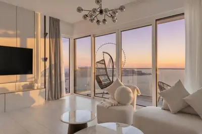 a living room with a view of the ocean at La Vie Jumeirah Beach Residence 3 Bedroom Beachfront Apartment with Palm Views in Dubai