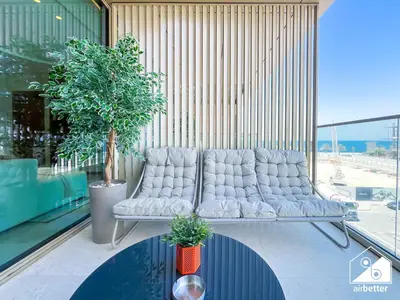 a waiting room with a white couch in a building at High End 1BR Palm Beachfront Pool Access in Dubai