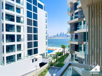 a view of the ocean from the balcony of a building at High End 1BR Palm Beachfront Pool Access in Dubai