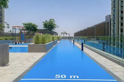 a large swimming pool with blue paint on it at Downtown Views II 2 Bedroom with City Skyline and Sea Views in Dubai