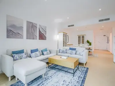 a living room with a couch and a table at TRPS - Marina Heights Tower, Dubai Marina - 2BR Upgraded Apartment - with Stunning Marina Skyline in Dubai