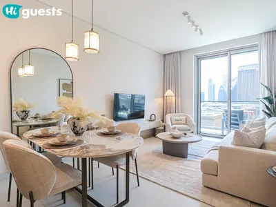 a living room with a table and a couch at HiGuests - Wake up to Burj Khalifa views in stunning 2 BR in Dubai
