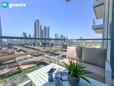 a balcony with a couch and a view of a city at HiGuests - Wake up to Burj Khalifa views in stunning 2 BR in Dubai