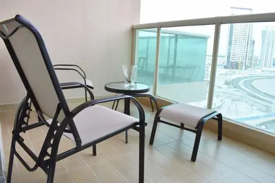 a room with two chairs and a table and a window at Relaxing and luxurious studio-Dubai in Dubai