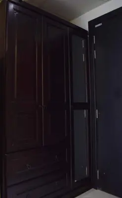 a black cabinet with glass doors in a room at Relaxing and luxurious studio-Dubai in Dubai
