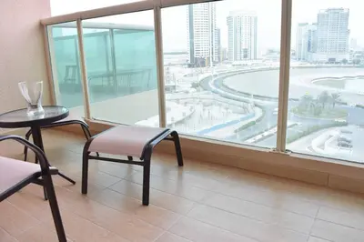 a room with a table and chairs and a large window at Relaxing and luxurious studio-Dubai in Dubai