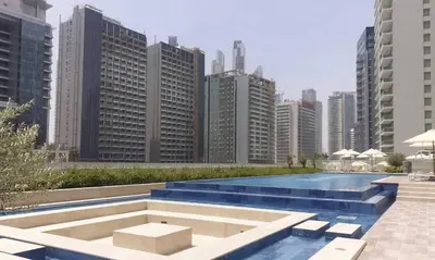 a pool in the middle of a city with tall buildings at Business Bay 2 Bedroom with Burj Khalifa Views in Dubai