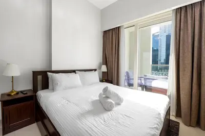 a hotel room with a bed with a towel on it at Business Bay 2 Bedroom with Burj Khalifa Views in Dubai