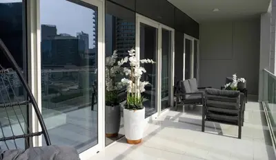 a balcony with vases of flowers on a building at Business Bay 2 Bedroom with Burj Khalifa Views in Dubai