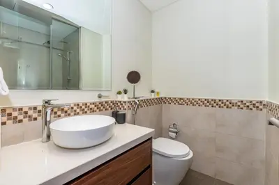 a bathroom with a sink and a toilet at Business Bay 2 Bedroom with Burj Khalifa Views in Dubai