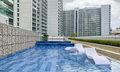 a swimming pool on the roof of a building with buildings at Business Bay 2 Bedroom with Burj Khalifa Views in Dubai