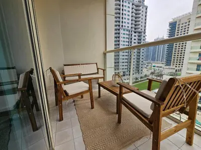 a balcony with two chairs and a table and a window at Luxury 1BR by dubai marina walk! in Dubai