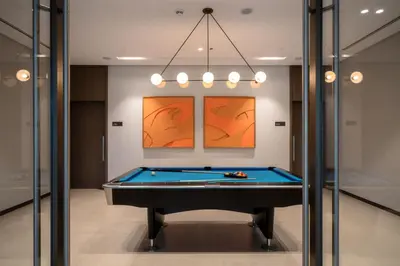 a billiard room with a pool table at Seraya at Grande Signature Residences in Dubai