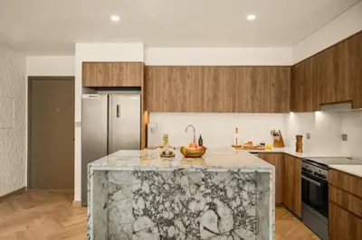 a kitchen with a island with a fruit on it at Seraya at Grande Signature Residences in Dubai